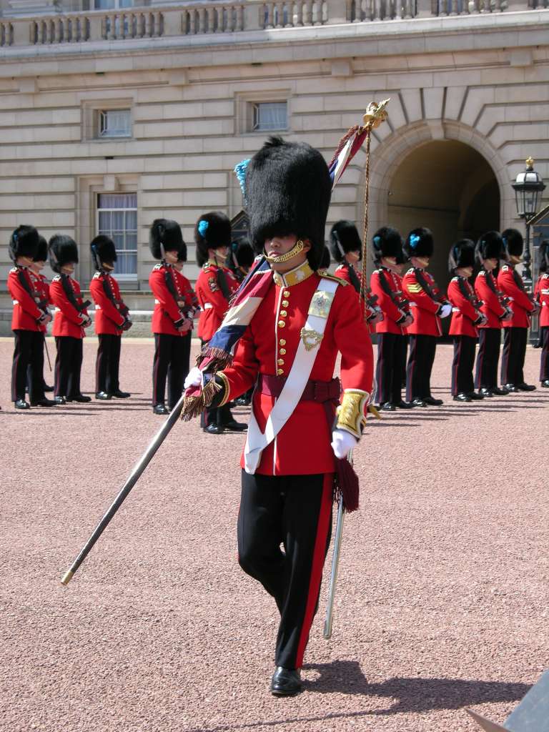 London 01 14 Buckingham Palace Changing of the Guard The Changing of the Guard takes place in the forecourt of Buckingham Palace and lasts a grueling 45 minutes. Members of the Old Guard repeatedly march to the fence within inches of the tourists, before turning and walking back.